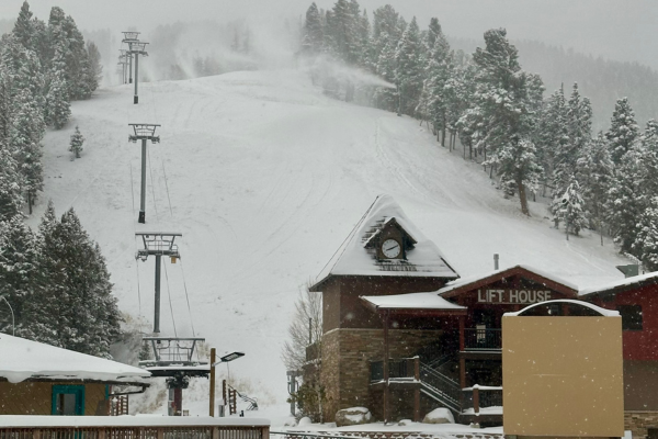 snow on mountain in front of lift chair